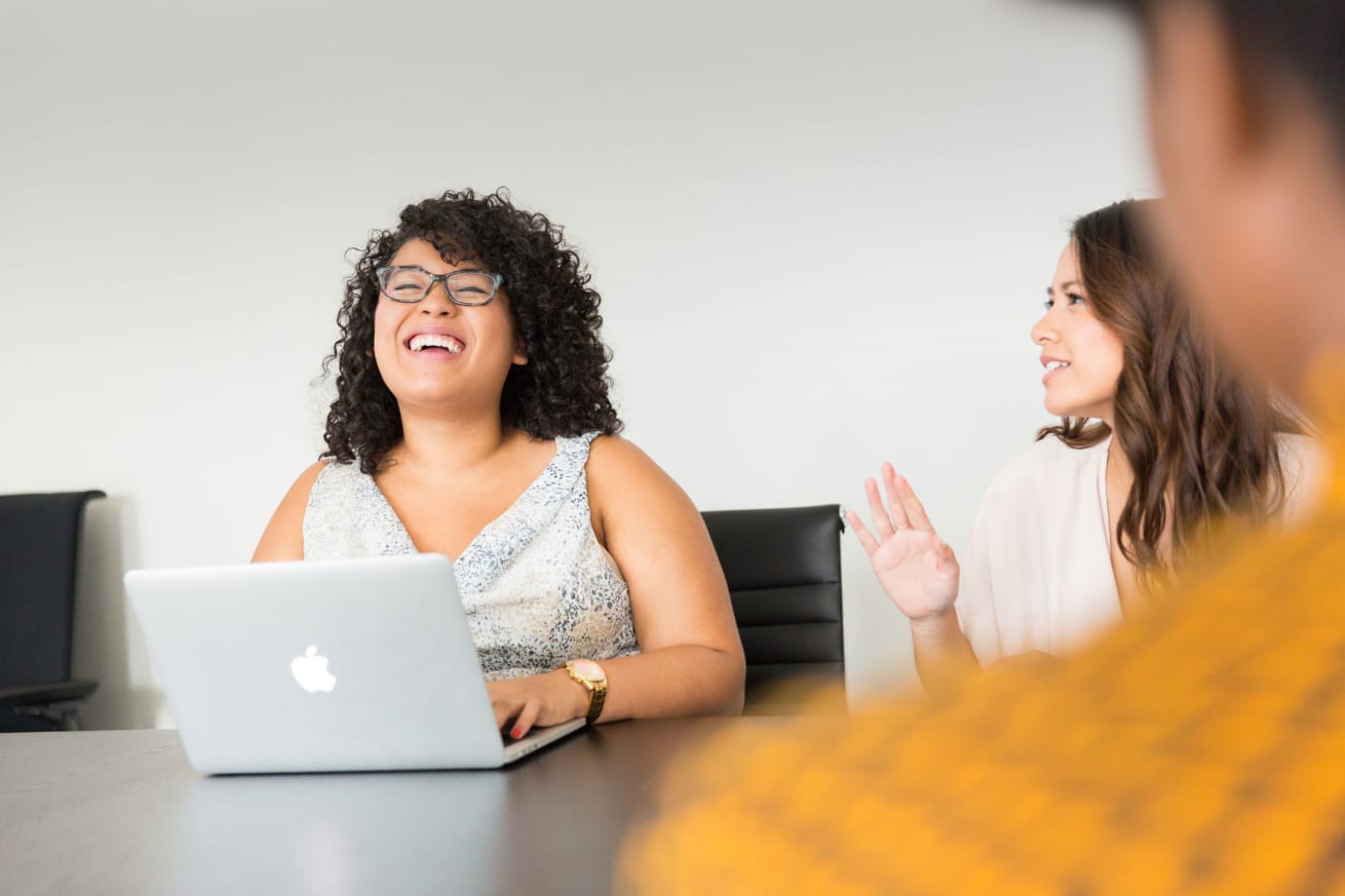 Woman laughing at meeting