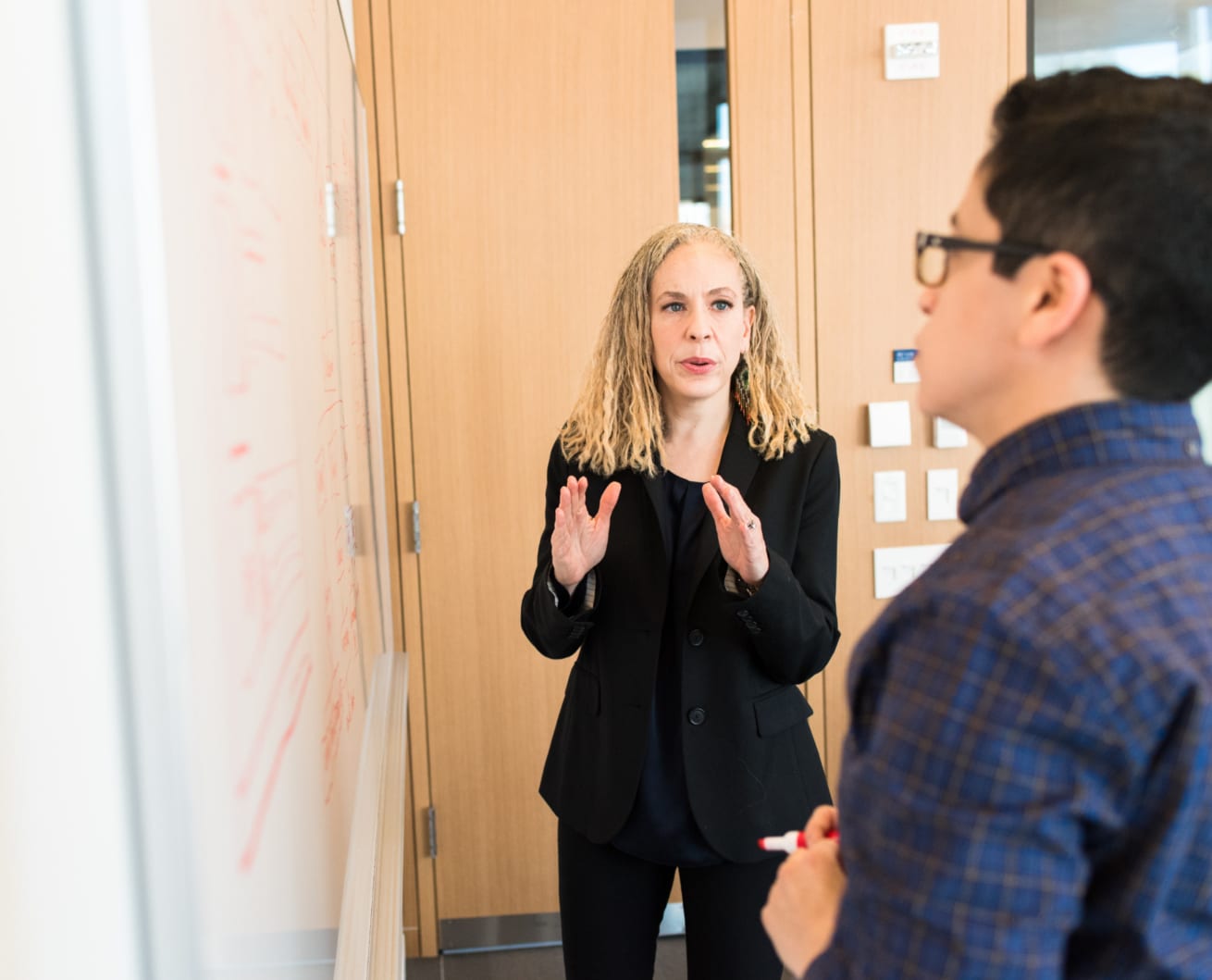 Woman explaining at a whiteboard