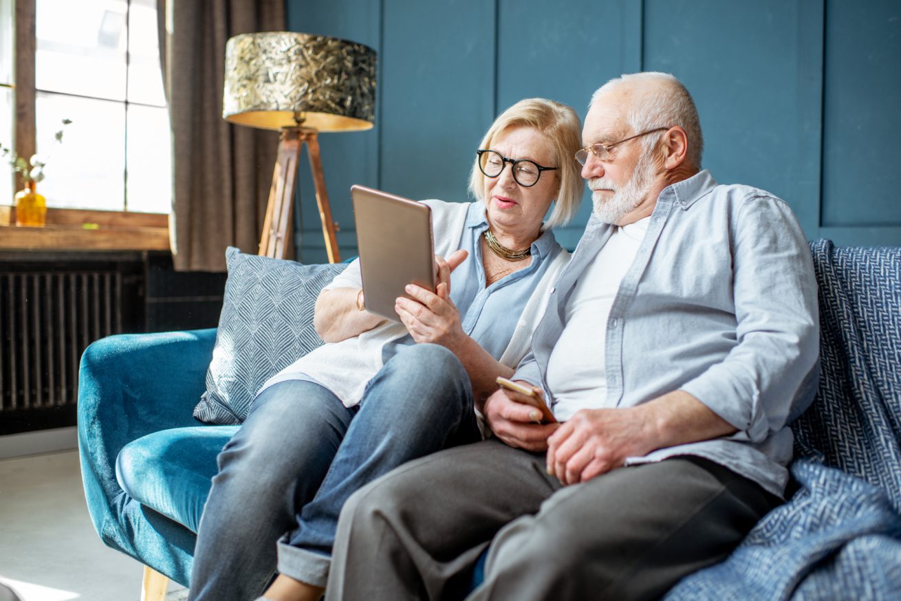 Senior couple with tablet at home