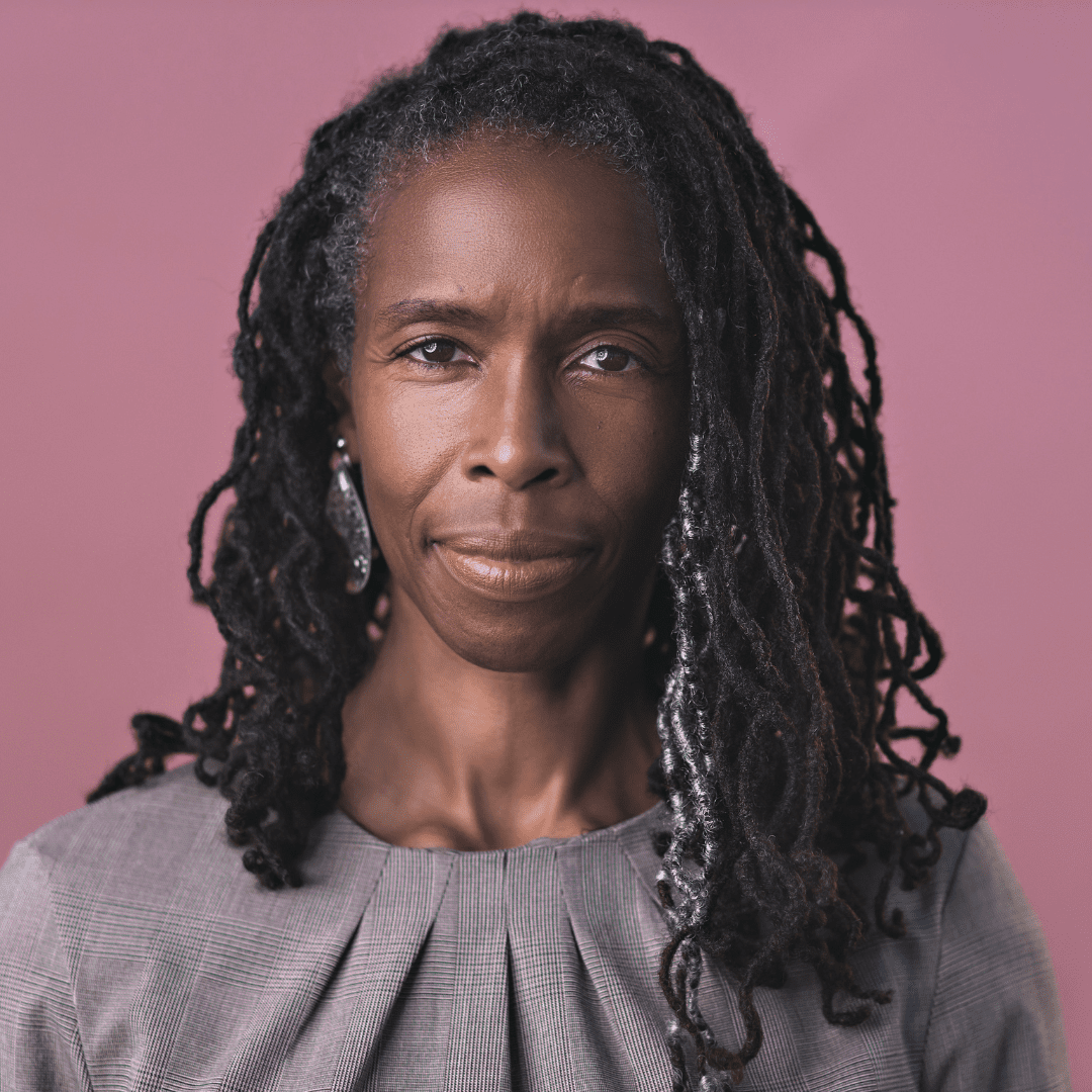 Lori Robinson headshot - Black woman with shoulder length dark hair and a pleated gray patterned top